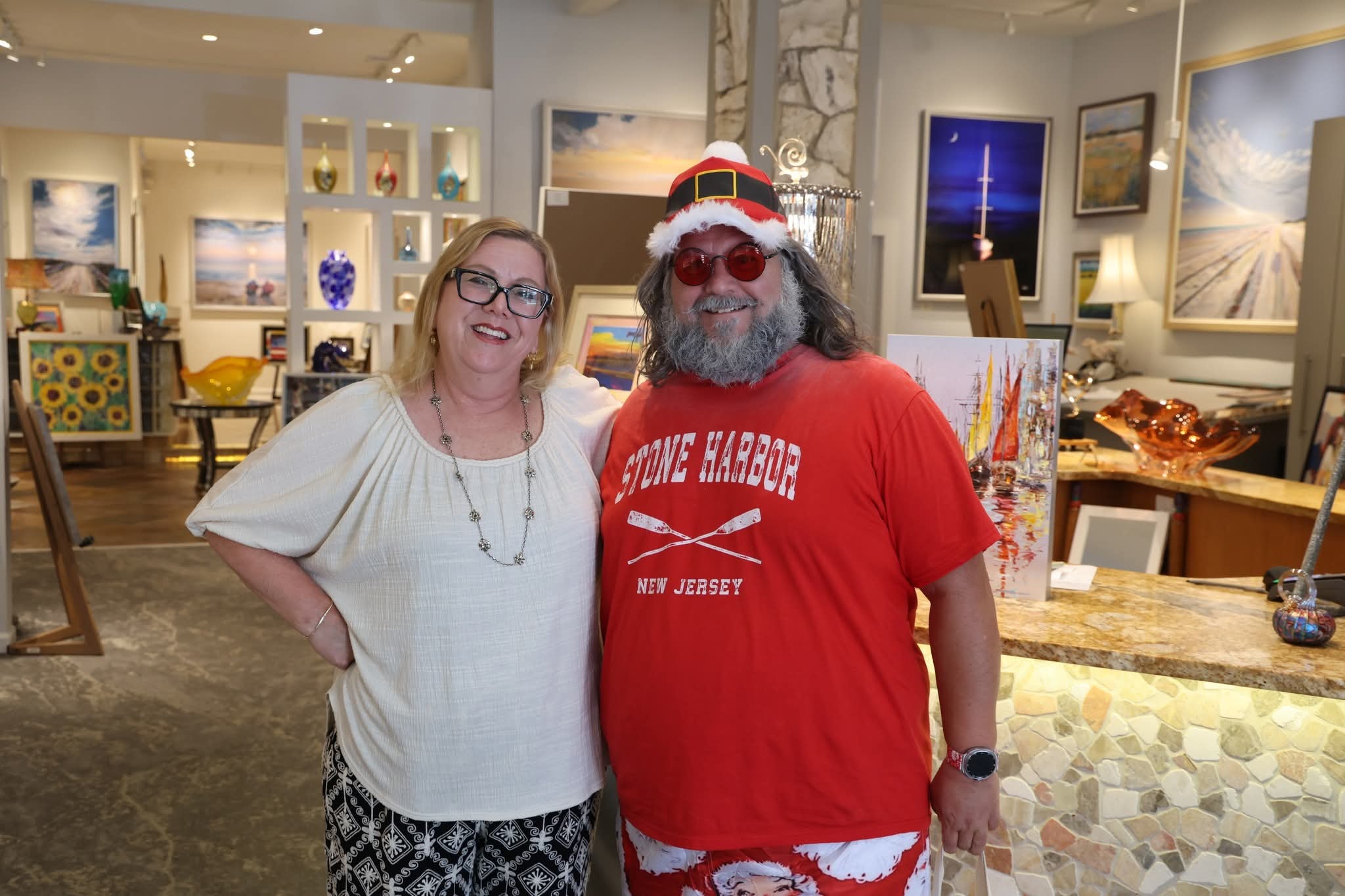 Cape May County Santa with a woman inside a beautiful coastal art gallery