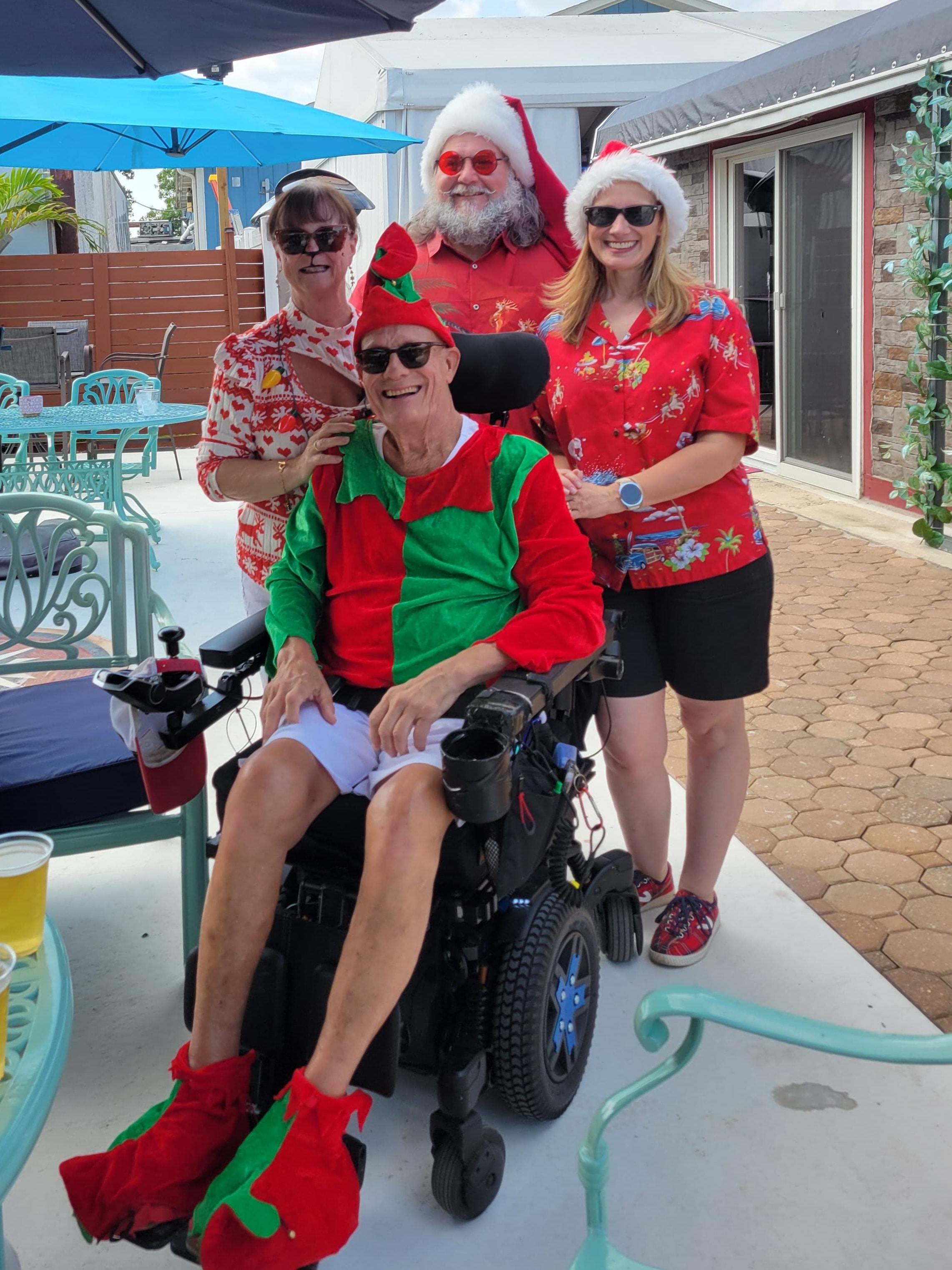 Cape May County Santa with a group including a man in an elf costume at an outdoor holiday event