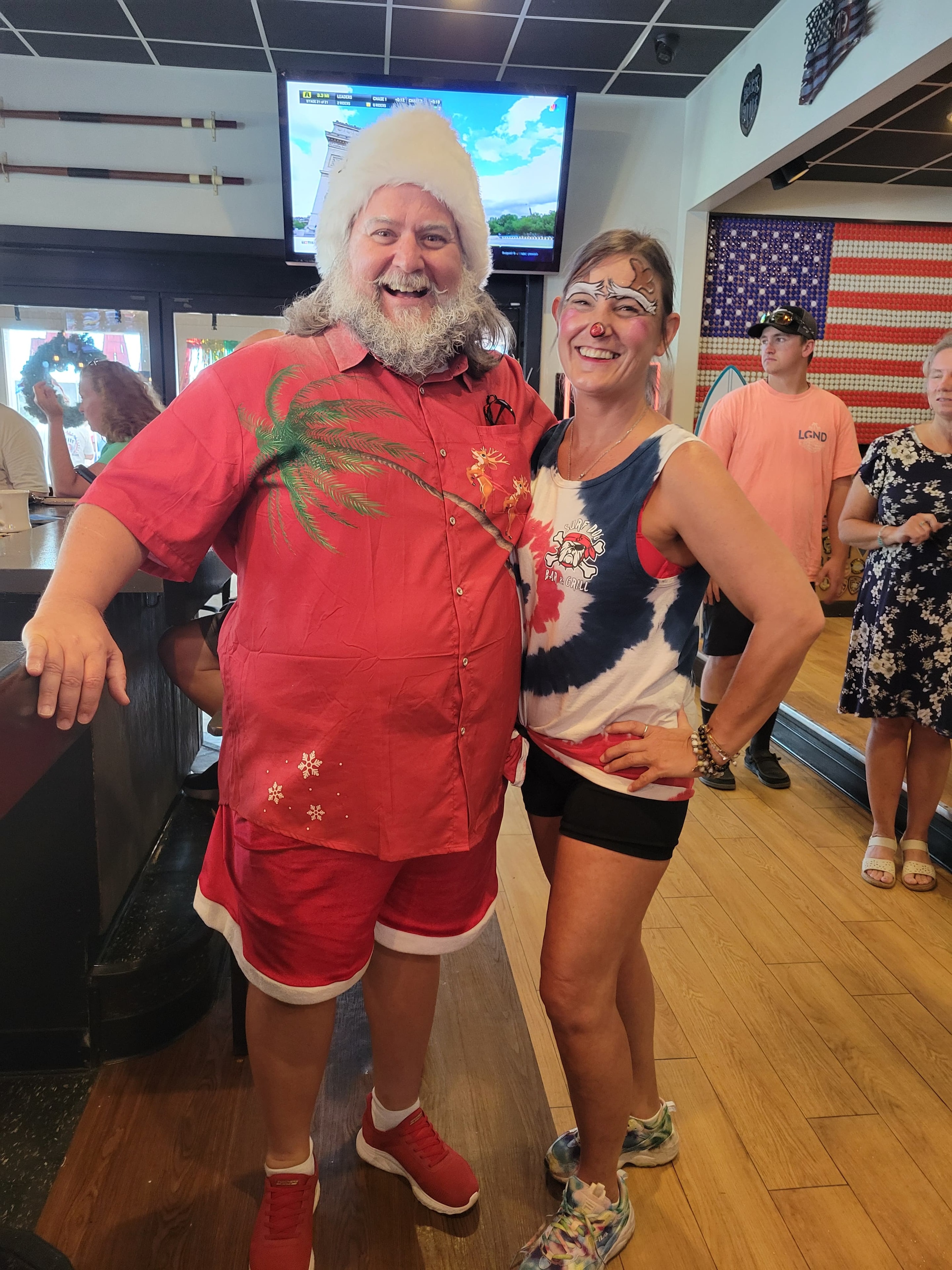 Cape May County Santa posing with a woman in clown face paint at Surf Dog Bar and Grill