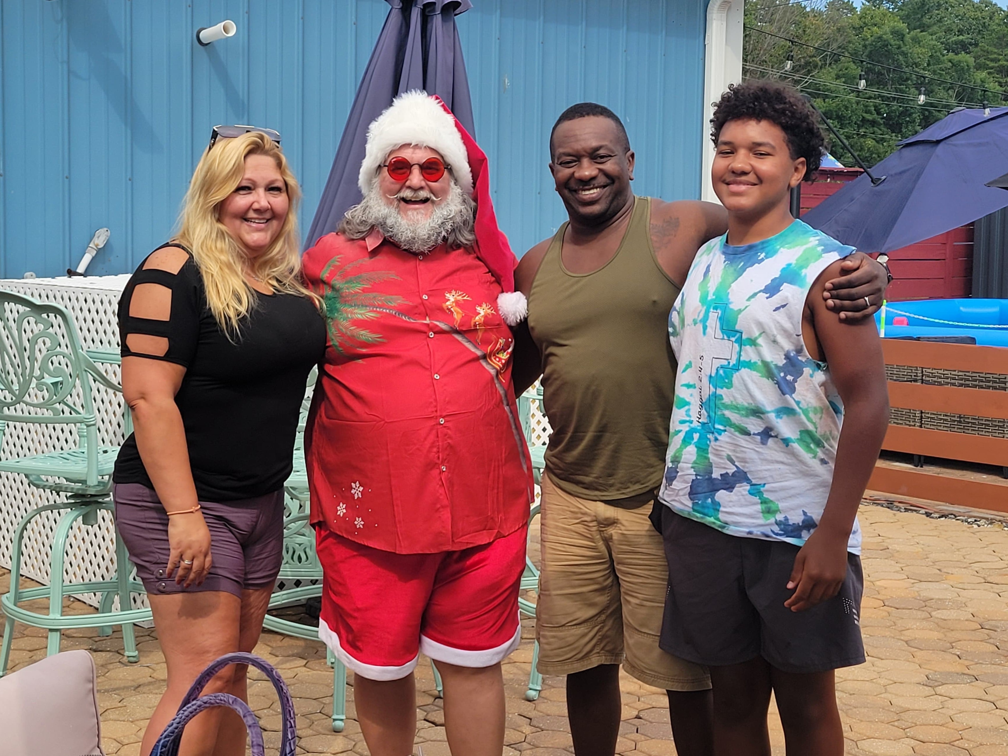 Cape May County Santa with a family of four at an outdoor patio event