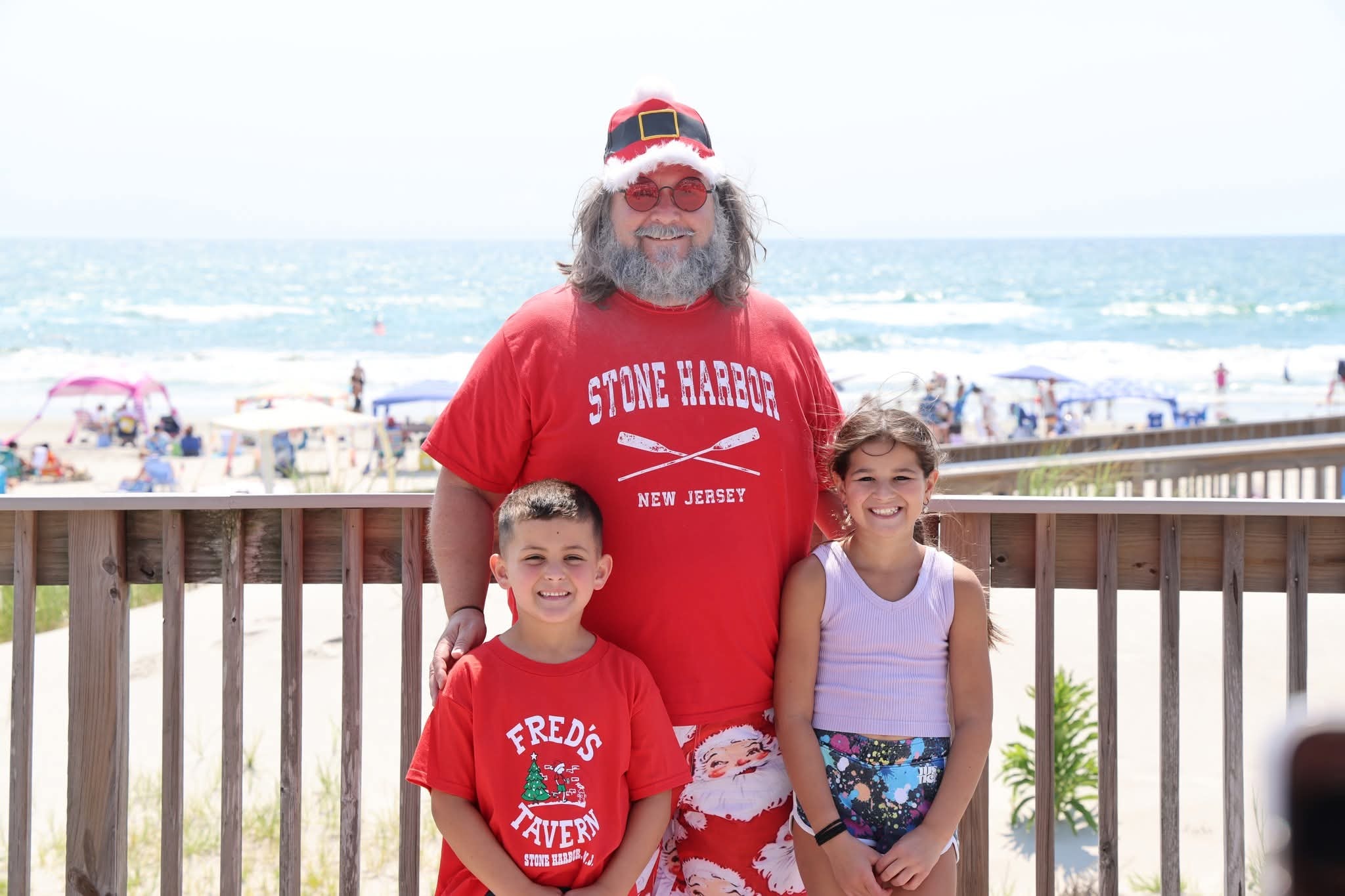 Cape May County Santa with two kids on the boardwalk, boy in Fred's Tavern shirt