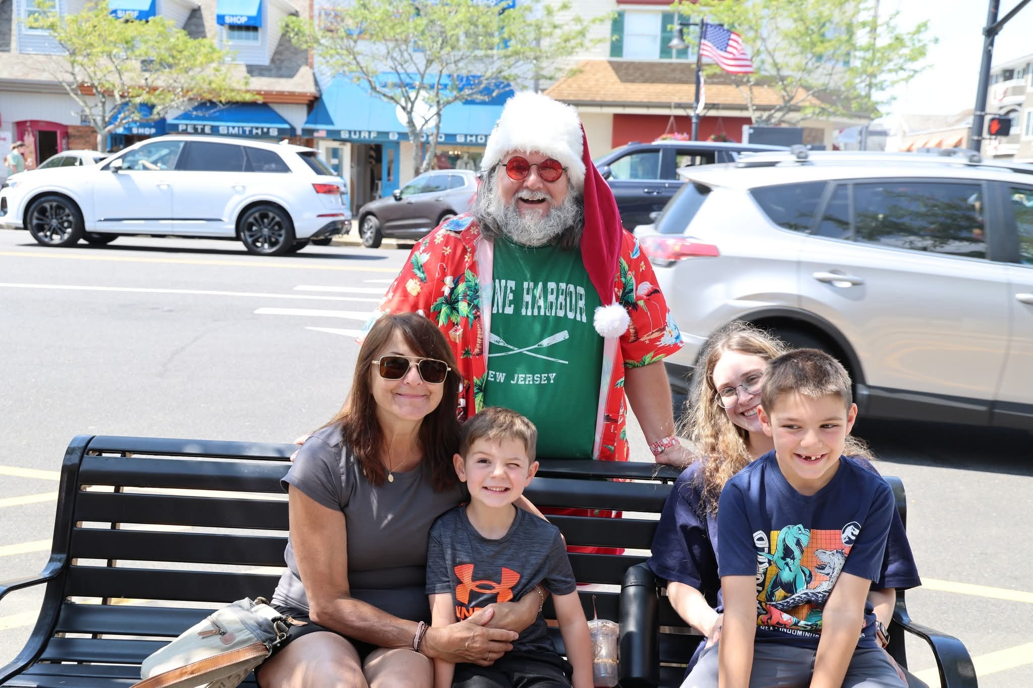 Cape May County Santa with a family on a bench on Stone Harbor's main street