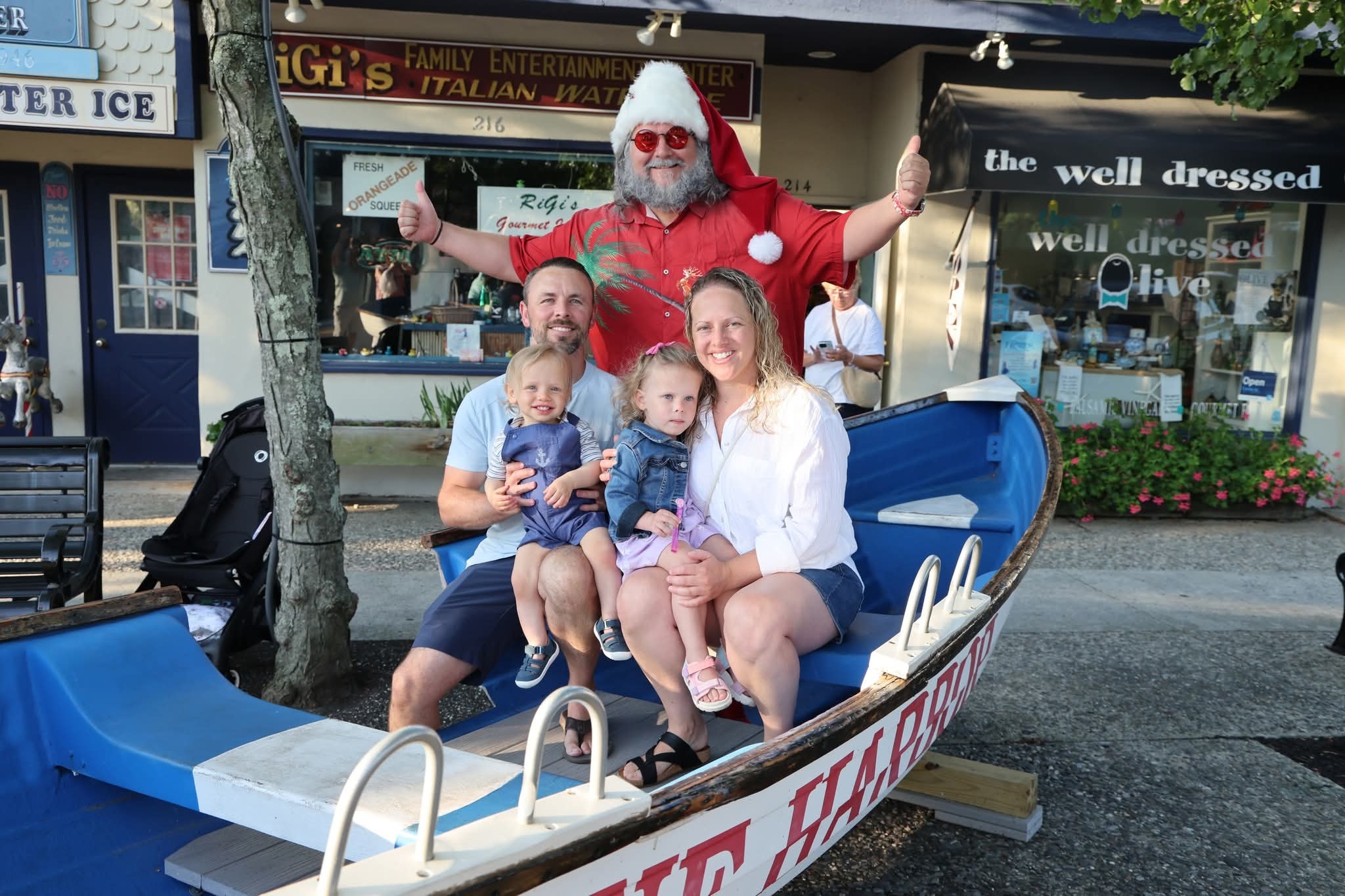 Cape May County Santa with a family of four in the Stone Harbor boat, Well Dressed Olive in background