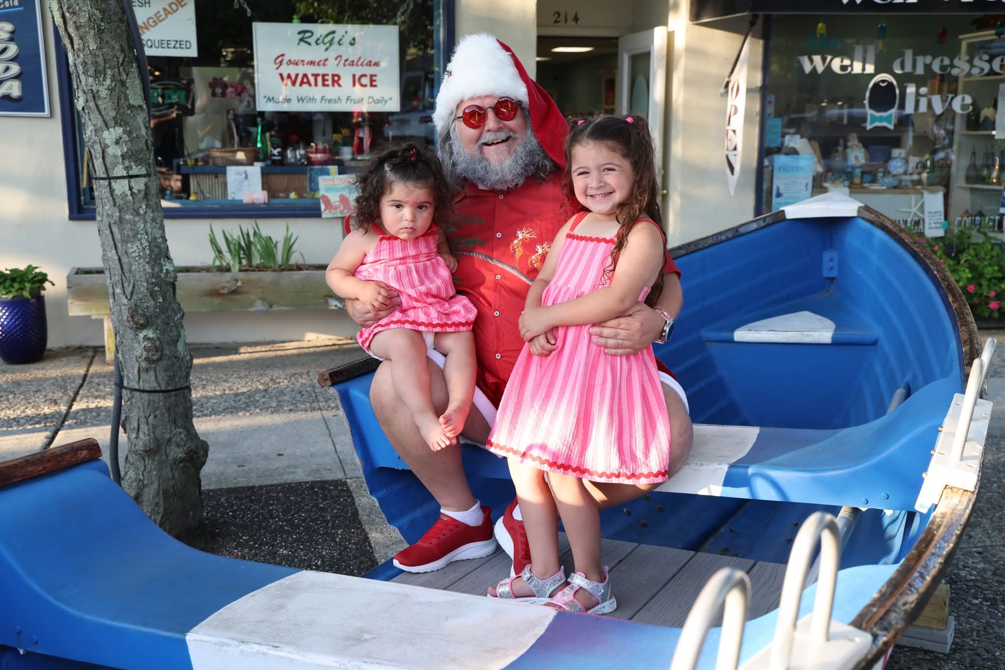 Cape May County Santa with two little girls in matching pink dresses in the Stone Harbor boat