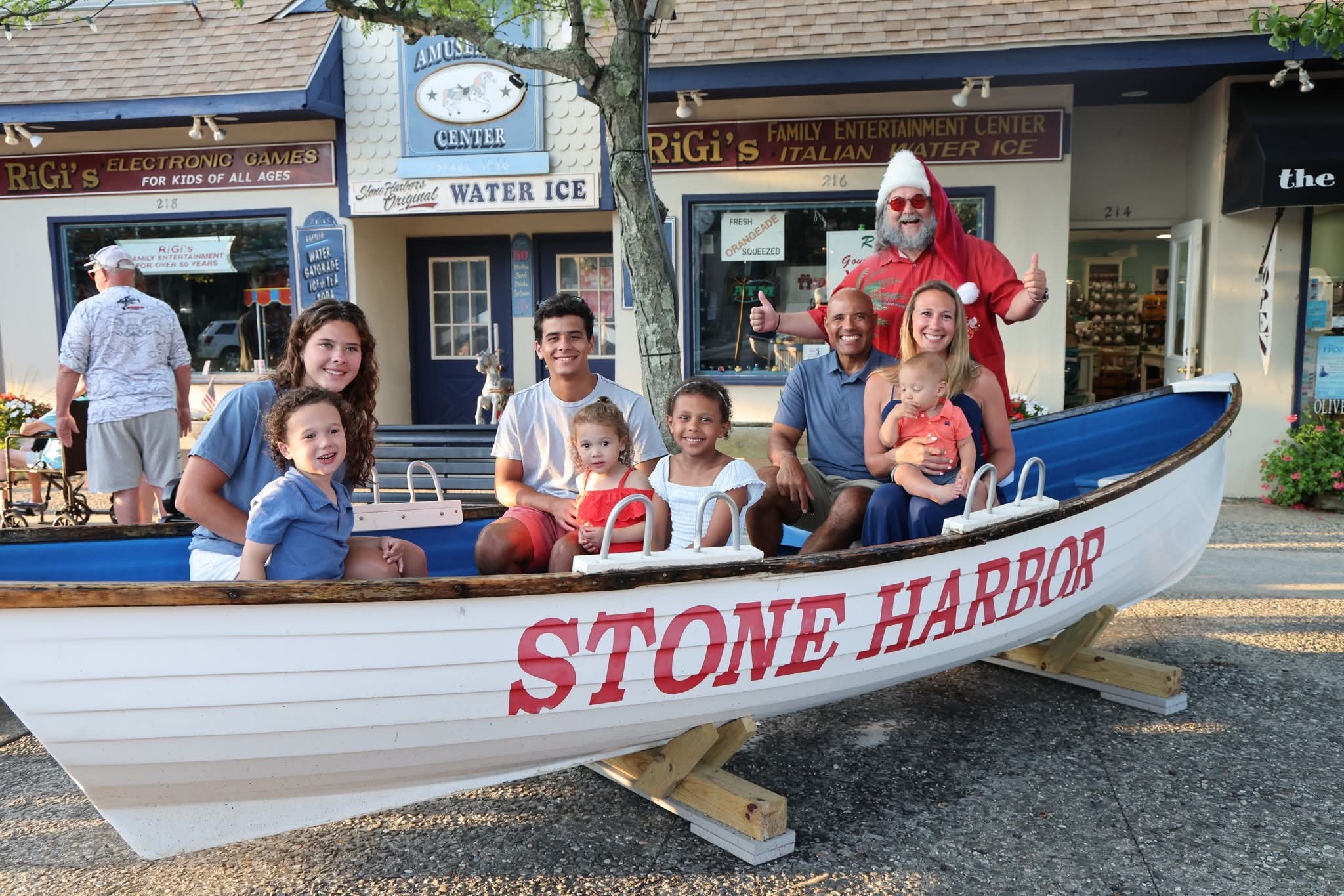 Cape May County Santa giving a thumbs up with a family of seven including a baby in the Stone Harbor boat