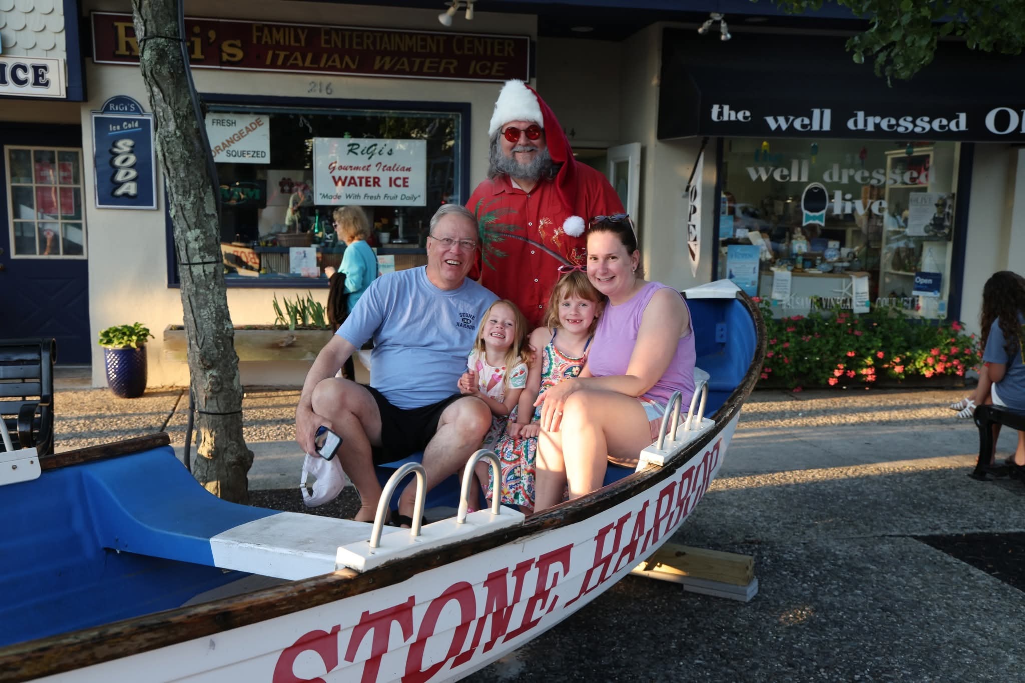 Cape May County Santa with a grandpa, two young girls, and a mom in the Stone Harbor boat