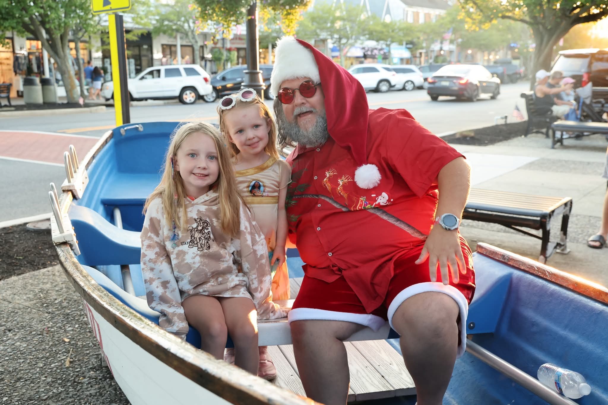 Cape May County Santa with two little girls including one in a Moana shirt in the Stone Harbor boat