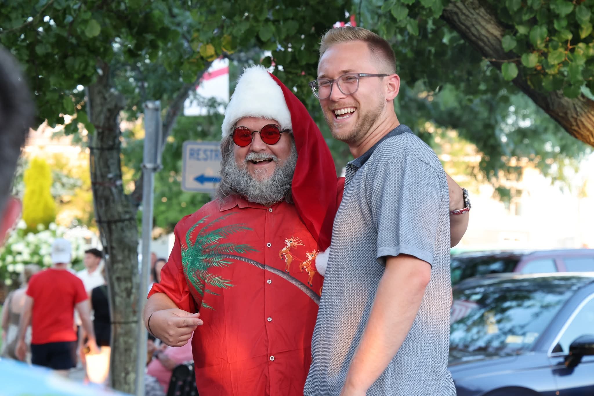 Cape May County Santa laughing with a young man on the Stone Harbor street